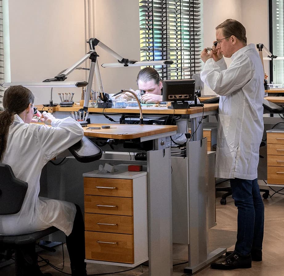 Watchmakers at their benches in the CVDK atelier