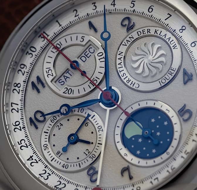 Chronograph subdials, calendar and moon phase on a white dial