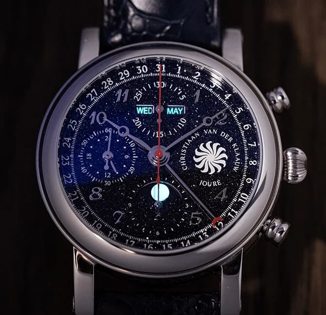 Dark chronograph dial with calendar windows and a luminous moon