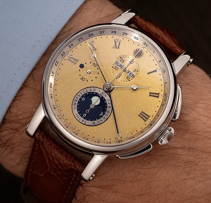 Chronograph with a golden dial and moon phase on the wrist