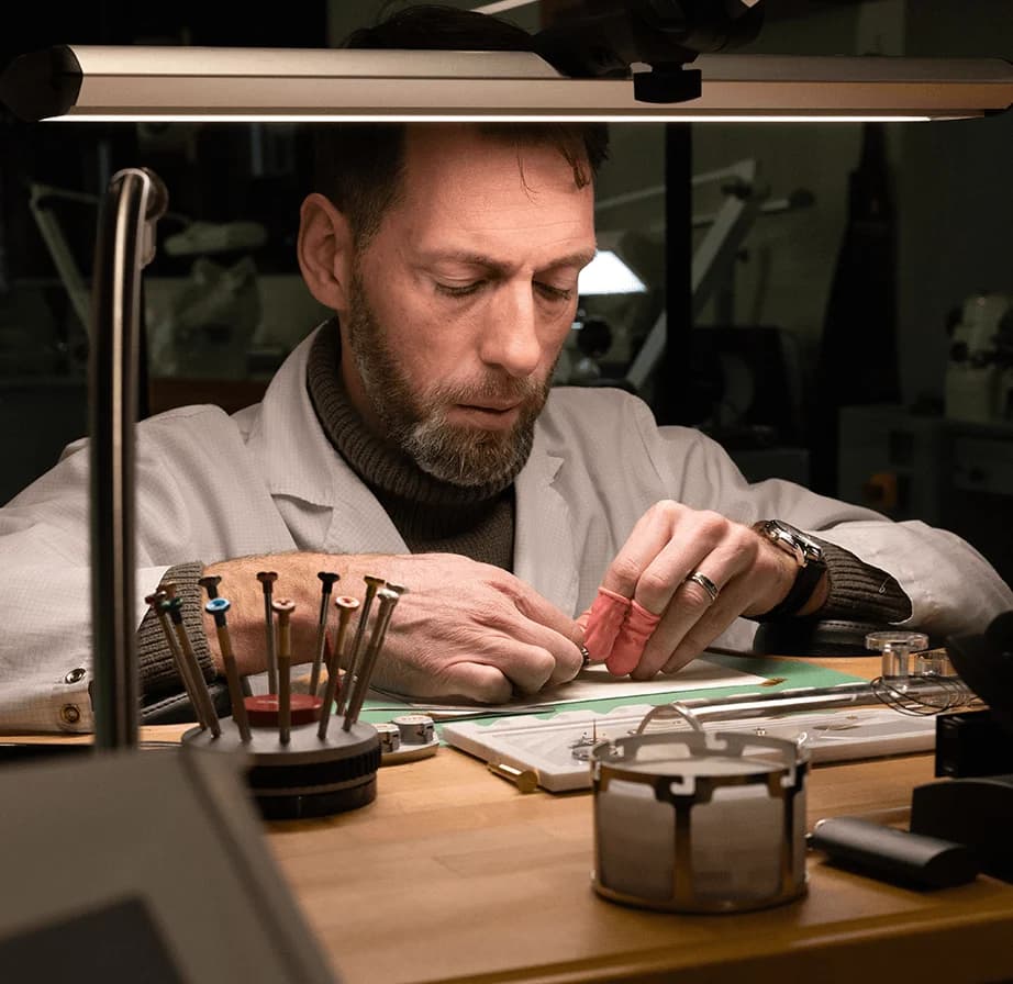 Watchmaker at the bench in the CVDK atelier