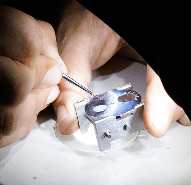 Hands adjusting a small component