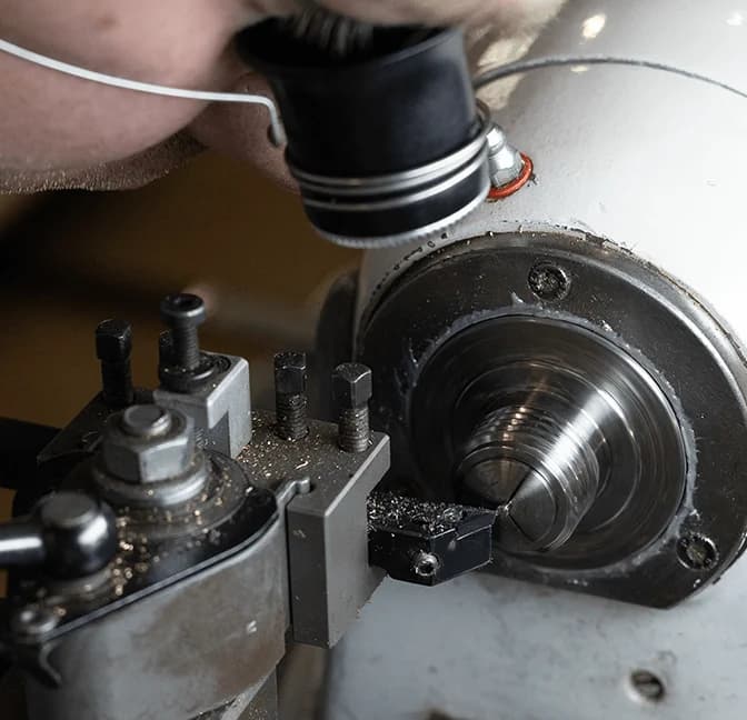 Watchmaker at a lathe under the loupe