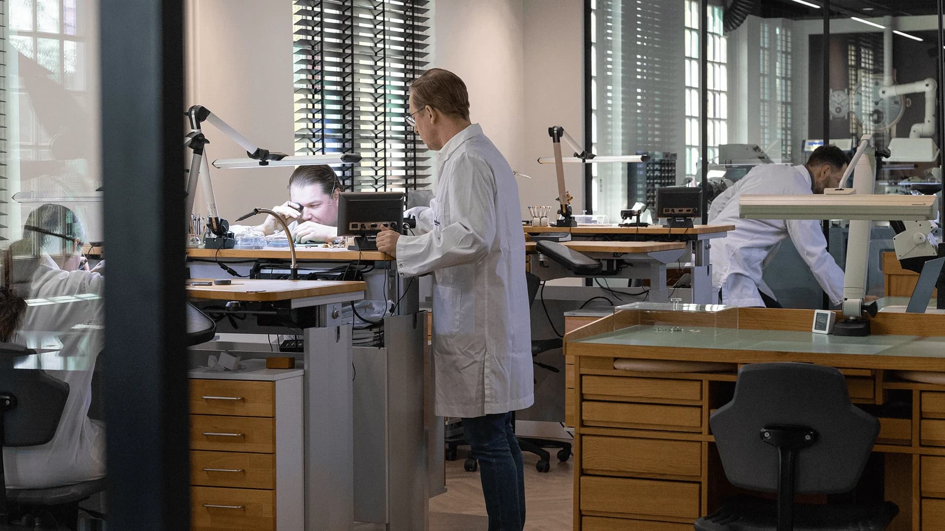 Watchmakers at their benches in the CVDK atelier in Naarden