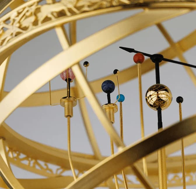 Brass orrery with planets on their arms