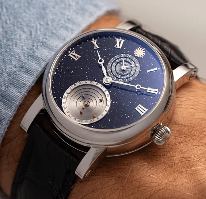 The mechanical Planetarium at 6 o'clock on the black aventurine dial