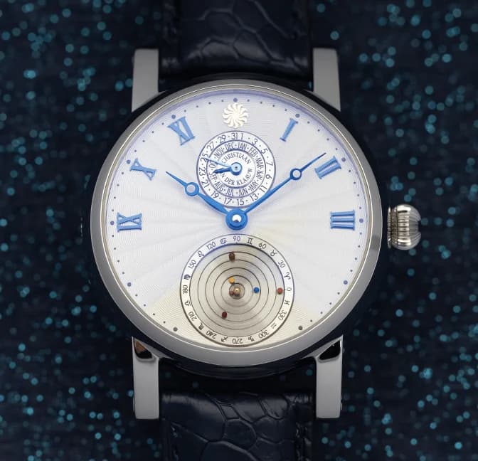 The mechanical Planetarium at 6 o'clock on the white dial