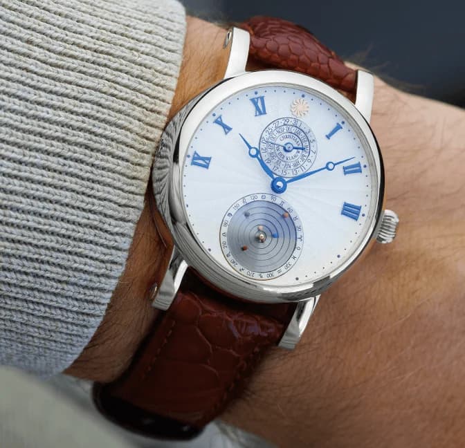 The mechanical Planetarium at 6 o'clock on the white dial