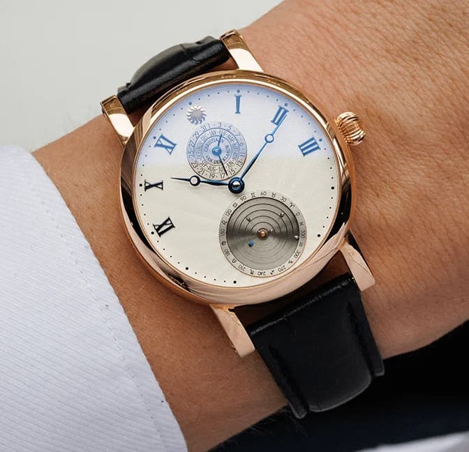 The mechanical Planetarium at 6 o'clock on the white dial