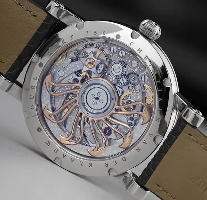 The mechanical Planetarium at 6 o'clock on the white dial