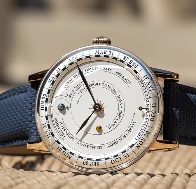 The silver sunburst dial with Venus, Earth and the Moon